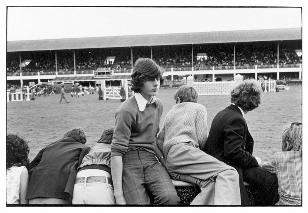 William Gedney, Boys leaning over and sitting on fence at races, Ballsbridge, 1974